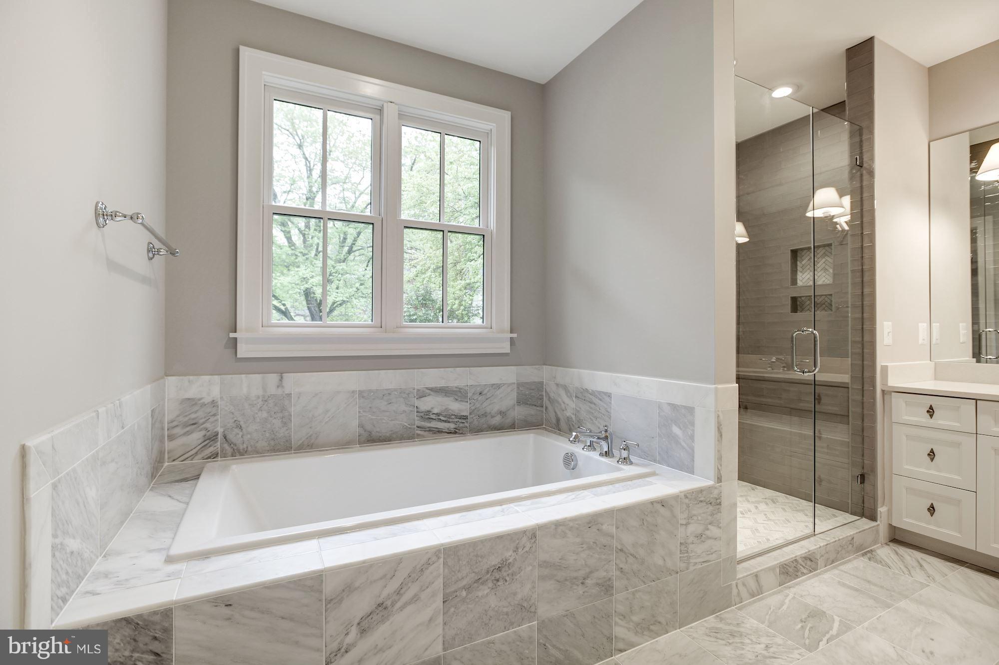 3030 North Stuart Street Arlington, VA 22207 - Photo 18 of 29 a white bath tub sitting next to a shower