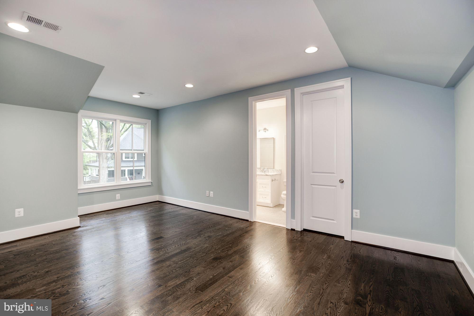 3030 North Stuart Street Arlington, VA 22207 - Photo 19 of 29 a view of an empty room with wooden floor and a window