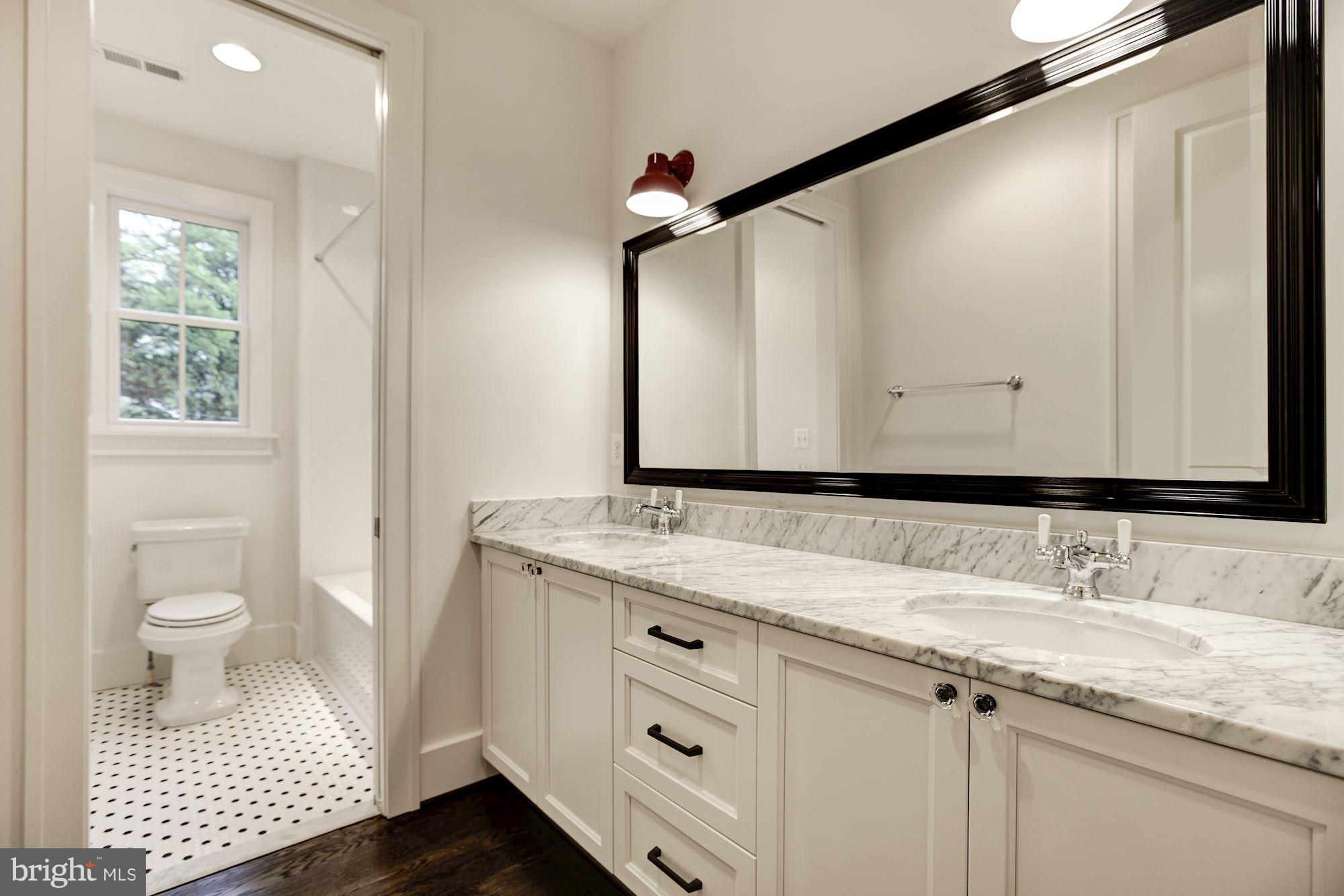 3030 North Stuart Street Arlington, VA 22207 - Photo 23 of 29 a bathroom with a sink a toilet and a mirror