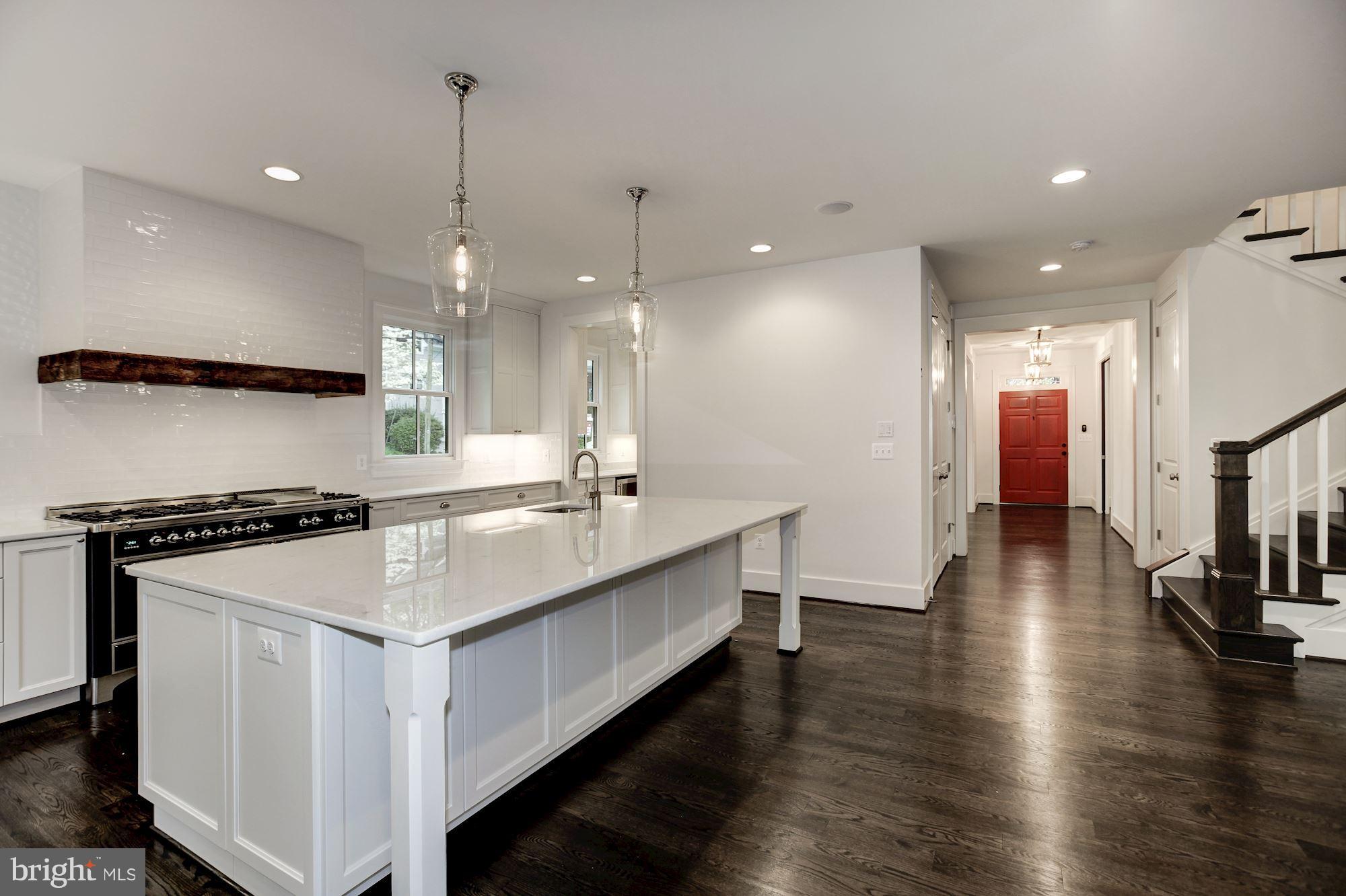 3030 North Stuart Street Arlington, VA 22207 - Photo 7 of 29 a kitchen with counter top space a sink stainless steel appliances and wooden floor
