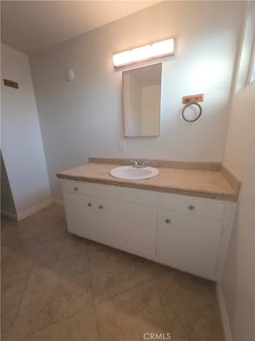 a bathroom with a granite countertop sink and mirror