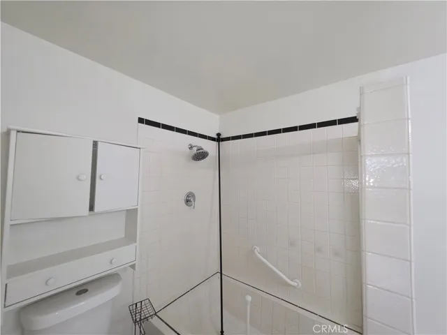 a bathroom with a shower and a glass door