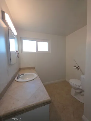 a bathroom with a toilet and a mirror