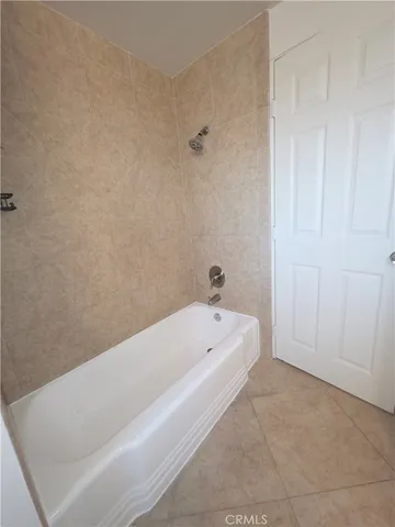a bathroom with a bathtub and shower