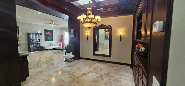a living room with furniture and a chandelier