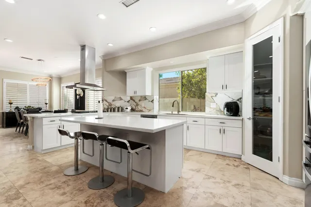 a bathroom with a toilet a sink a light fixture and a mirror