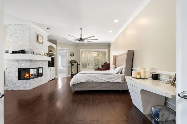 a spacious bedroom with a bed and a fireplace