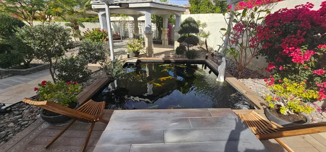 a view of a patio with a dining table and chairs with wooden floor and fence