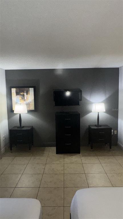 6165 Carrier Drive, Unit 1114 Orlando, FL 32819 - Photo 11 of 31 a en suite bathroom with a toilet a sink and mirror