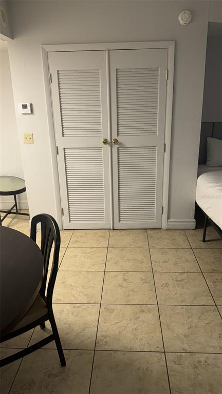 6165 Carrier Drive, Unit 1114 Orlando, FL 32819 - Photo 12 of 31 a view of an empty room with glass door and chair