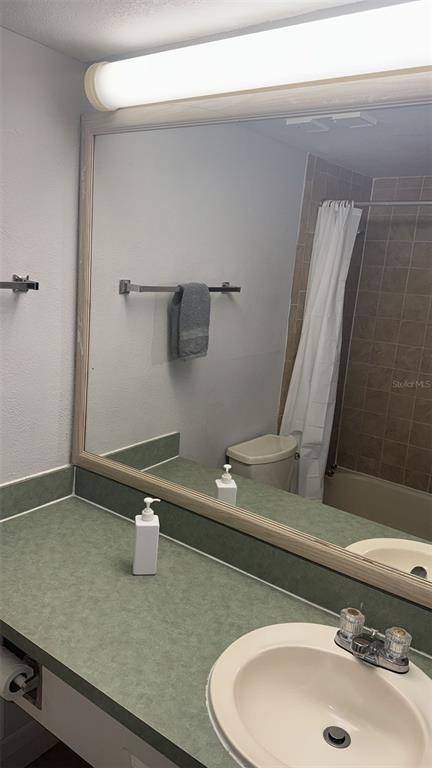 6165 Carrier Drive, Unit 1114 Orlando, FL 32819 - Photo 14 of 31 a bathroom with a sink and a mirror