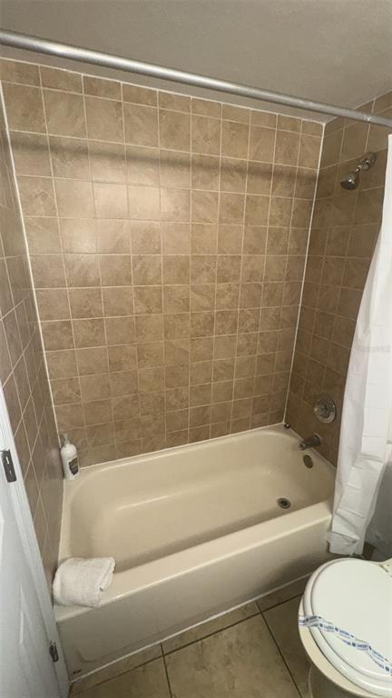 6165 Carrier Drive, Unit 1114 Orlando, FL 32819 - Photo 15 of 31 a bathroom with a toilet and a bathtub