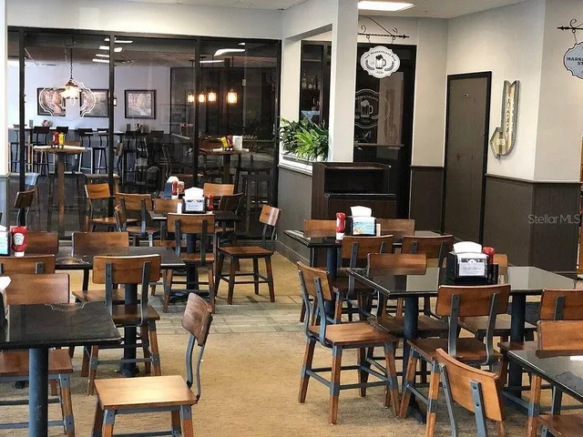 a kitchen with a table chairs and cabinets