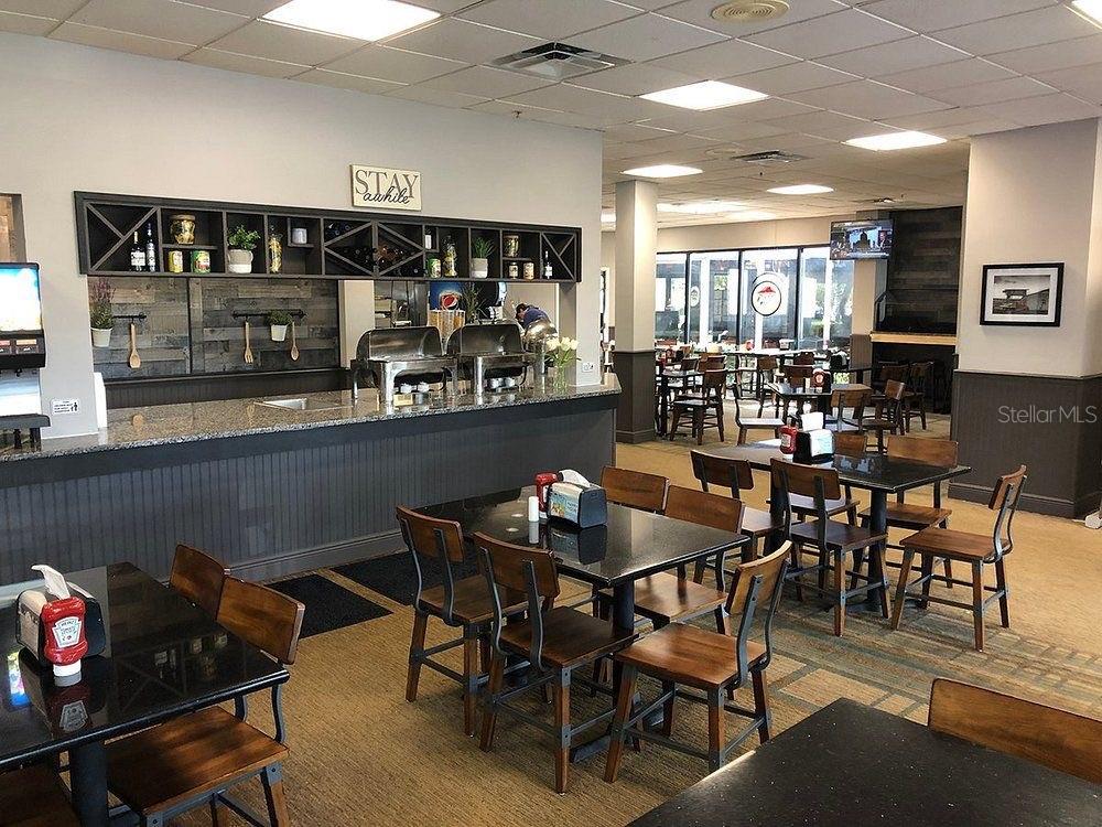 6165 Carrier Drive, Unit 1114 Orlando, FL 32819 - Photo 26 of 31 a dining room with furniture and wooden floor