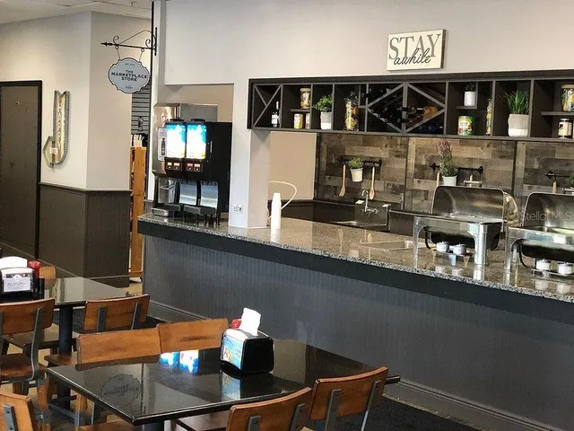 a view of backyard with deck and outdoor seating