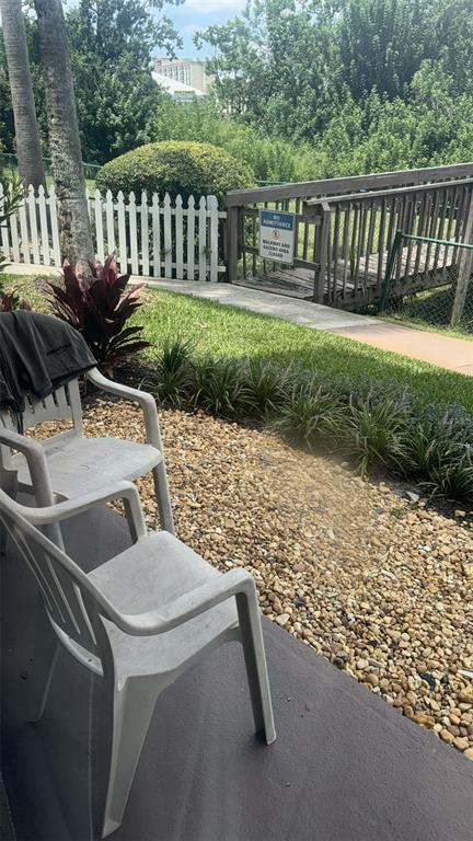 6165 Carrier Drive, Unit 1114 Orlando, FL 32819 - Photo 29 of 31 a view of backyard with deck and outdoor seating