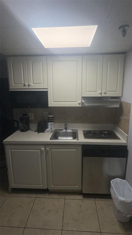 6165 Carrier Drive, Unit 1114 Orlando, FL 32819 - Photo 4 of 31 a kitchen with granite countertop a sink and a stove