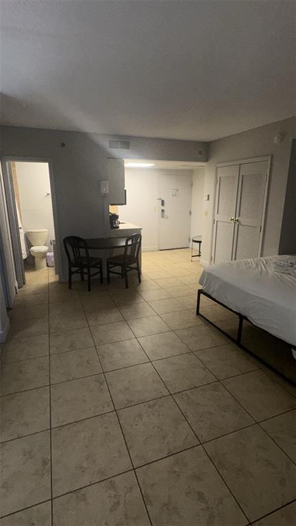 6165 Carrier Drive, Unit 1114 Orlando, FL 32819 - Photo 5 of 31 a bedroom with furniture and a window