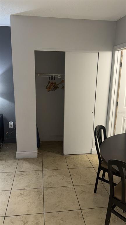 6165 Carrier Drive, Unit 1114 Orlando, FL 32819 - Photo 8 of 31 a view of a hallway with furniture and a potted plant