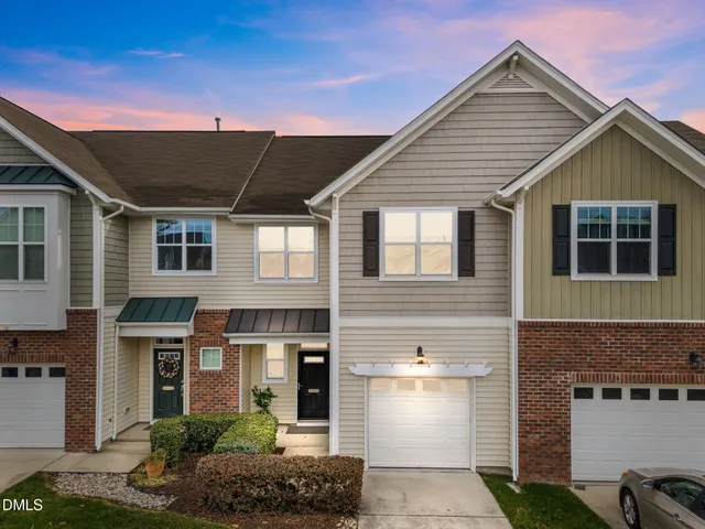 a front view of a house with plants