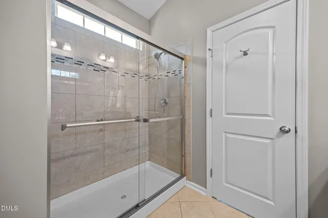 a bathroom with a glass shower door