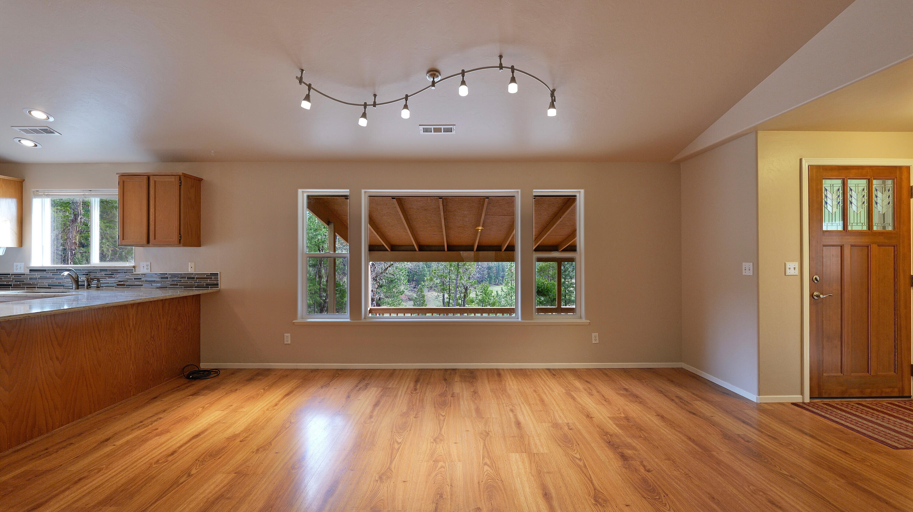 204 Shipley Terrace Prospect, OR 97536 - Photo 7 of 61 an empty room with wooden floor and windows