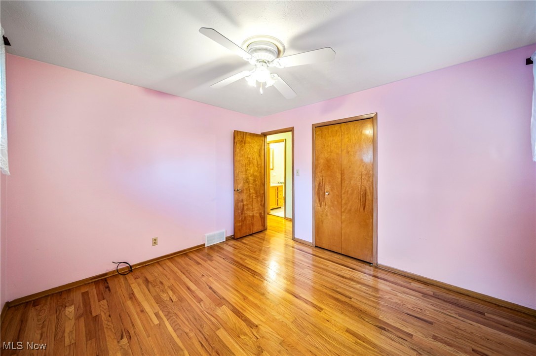 30888 Harrison Road Wickliffe, OH 44092 - Photo 19 of 33 Unfurnished bedroom featuring light wood-style flooring, a closet, and ceiling fan