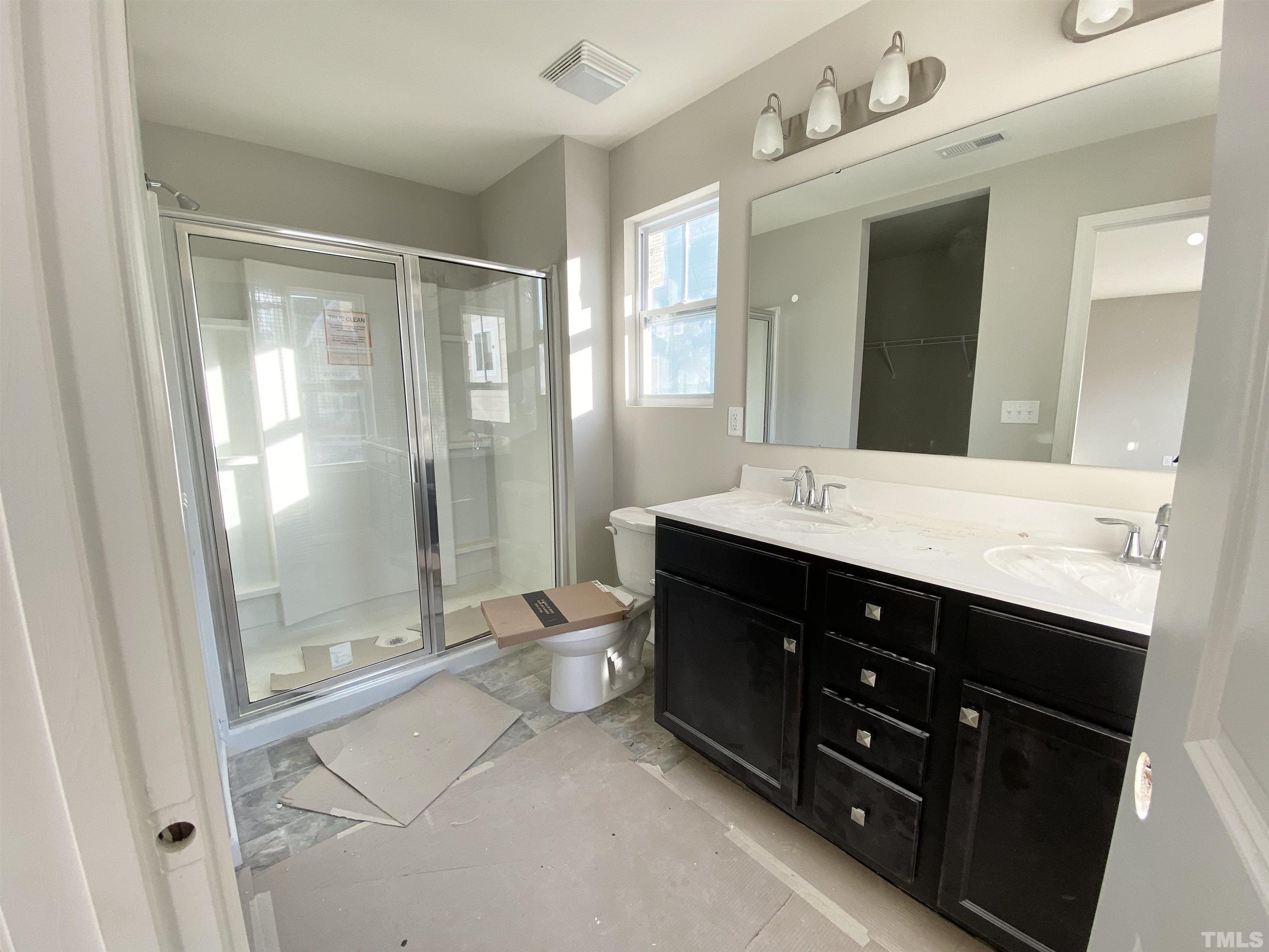 618 Metro Station Apex, NC 27502 - Photo 7 of 11 a bathroom with a double vanity sink mirror and shower