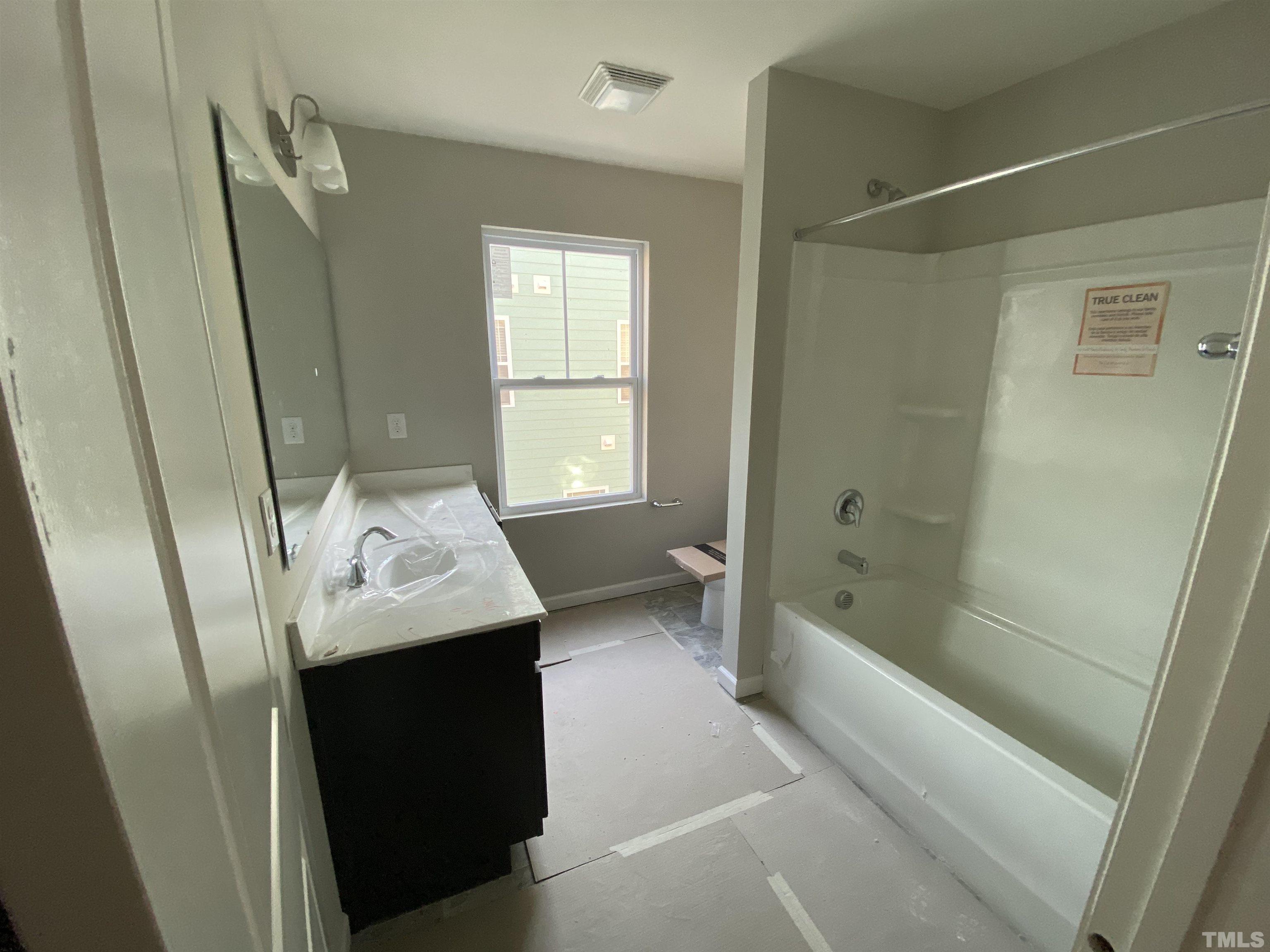 618 Metro Station Apex, NC 27502 - Photo 10 of 11 a bathroom with a sink a toilet and shower