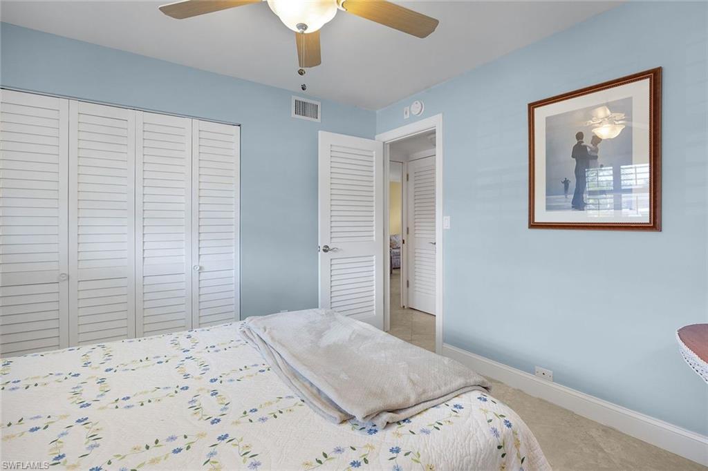41 High Point Circle South, Unit 107 Naples, FL 34103 - Photo 13 of 29 a bedroom with a bed and a window