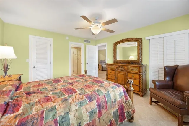 a spacious bedroom with a bed dresser and a window