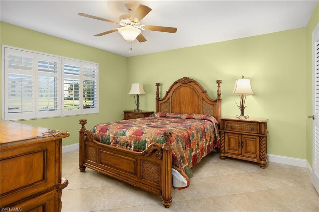 41 High Point Circle South, Unit 107 Naples, FL 34103 - Photo 15 of 29 a spacious bedroom with a bed dresser and a window