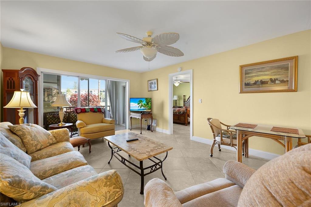 41 High Point Circle South, Unit 107 Naples, FL 34103 - Photo 16 of 29 a living room with furniture and a large window