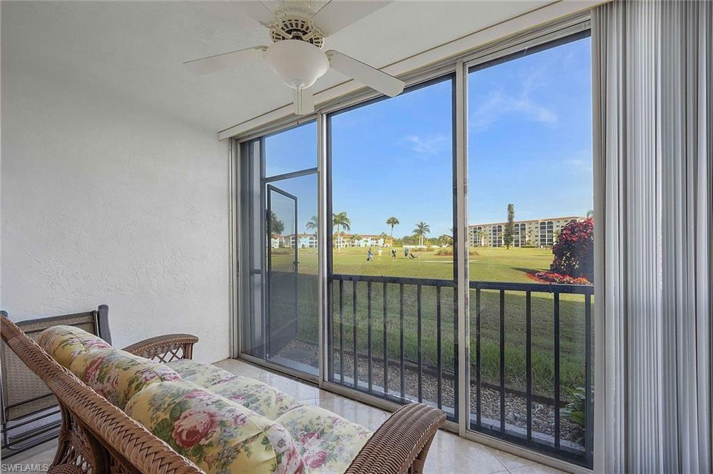 41 High Point Circle South, Unit 107 Naples, FL 34103 - Photo 19 of 29 a bedroom with furniture and large window