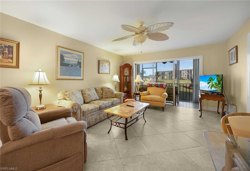 41 High Point Circle South, Unit 107 Naples, FL 34103 - Photo 2 of 29 a living room with furniture and a view of kitchen