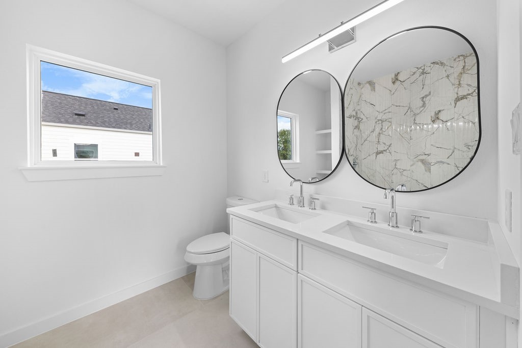 9630 Burden Street Houston, TX 77093 - Photo 14 of 16 a bathroom with a sink and a mirror