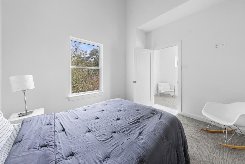 9630 Burden Street Houston, TX 77093 - Photo 10 of 16 a bedroom with a bed and a chair