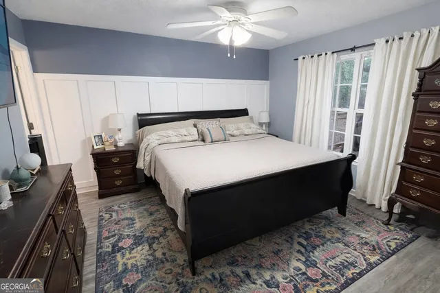 a bedroom with a bed closet and a flat tv screen