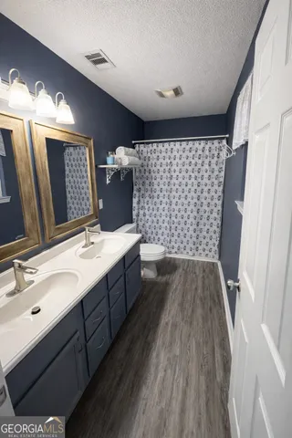 a bathroom with a sink mirror and shower