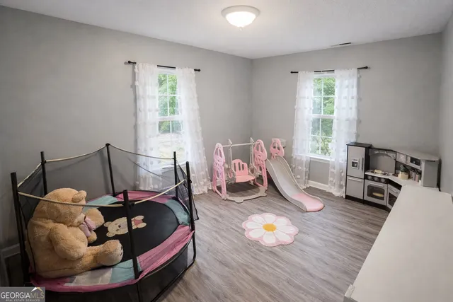 a bed room with furniture and wooden floor