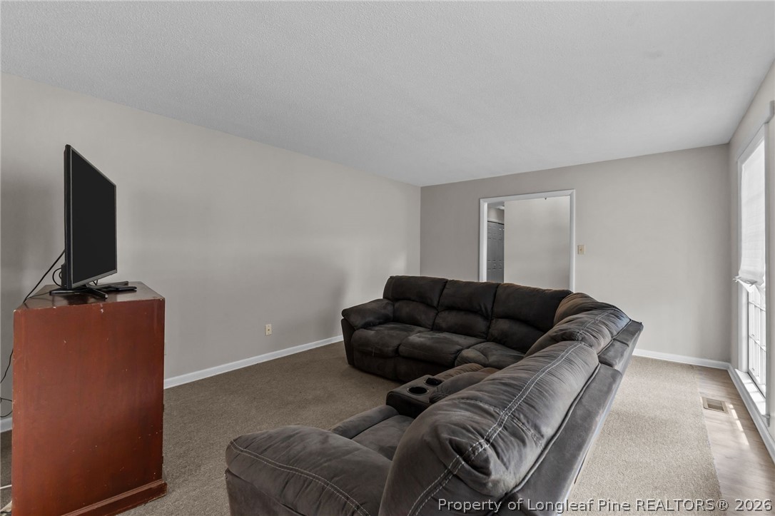 908 Ruton Court Fayetteville, NC 28303 - Photo 7 of 29 a living room with furniture and a flat screen tv