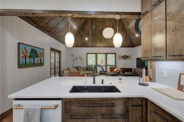 a kitchen with granite countertop a refrigerator and a sink