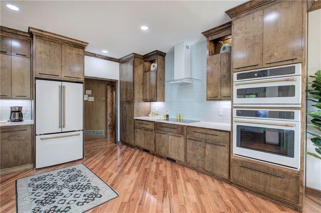 450 Little Hendricks Mountain Road Jasper, GA 30143 - Photo 16 of 61 a kitchen with granite countertop a refrigerator and a sink