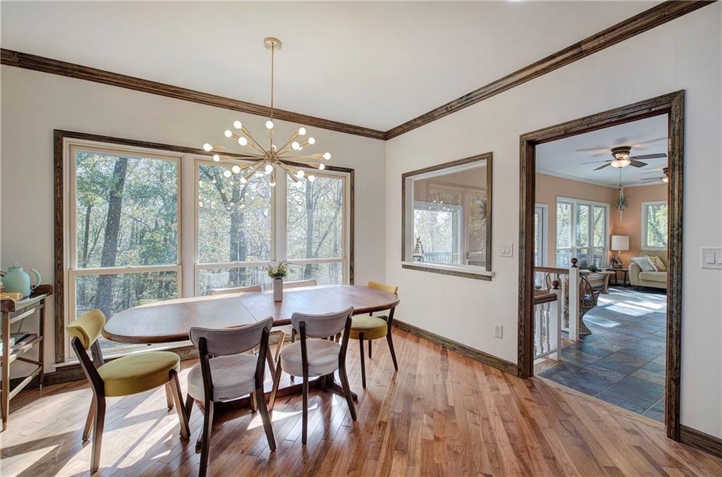 450 Little Hendricks Mountain Road Jasper, GA 30143 - Photo 17 of 61 a dining room with furniture large windows and a chandelier