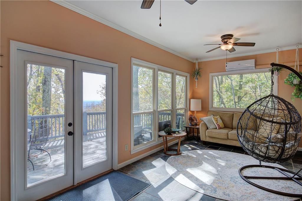 450 Little Hendricks Mountain Road Jasper, GA 30143 - Photo 19 of 61 a living room with furniture and a floor to ceiling window