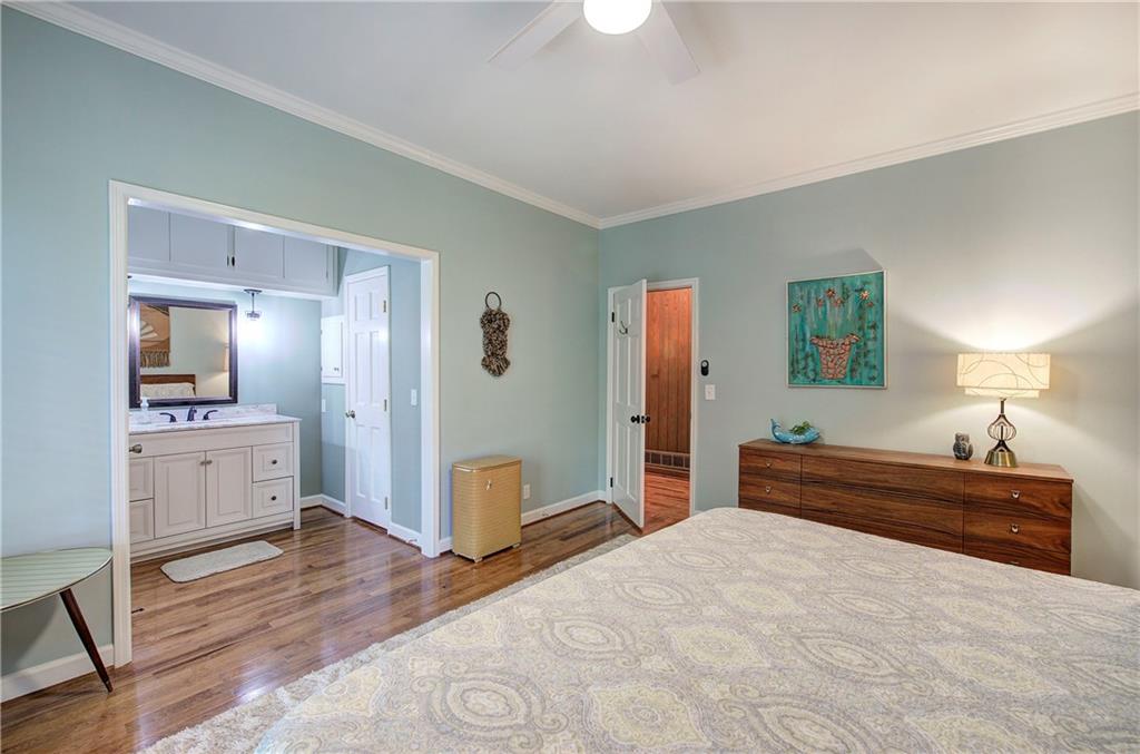 450 Little Hendricks Mountain Road Jasper, GA 30143 - Photo 30 of 61 a bedroom with a bed and a chandelier