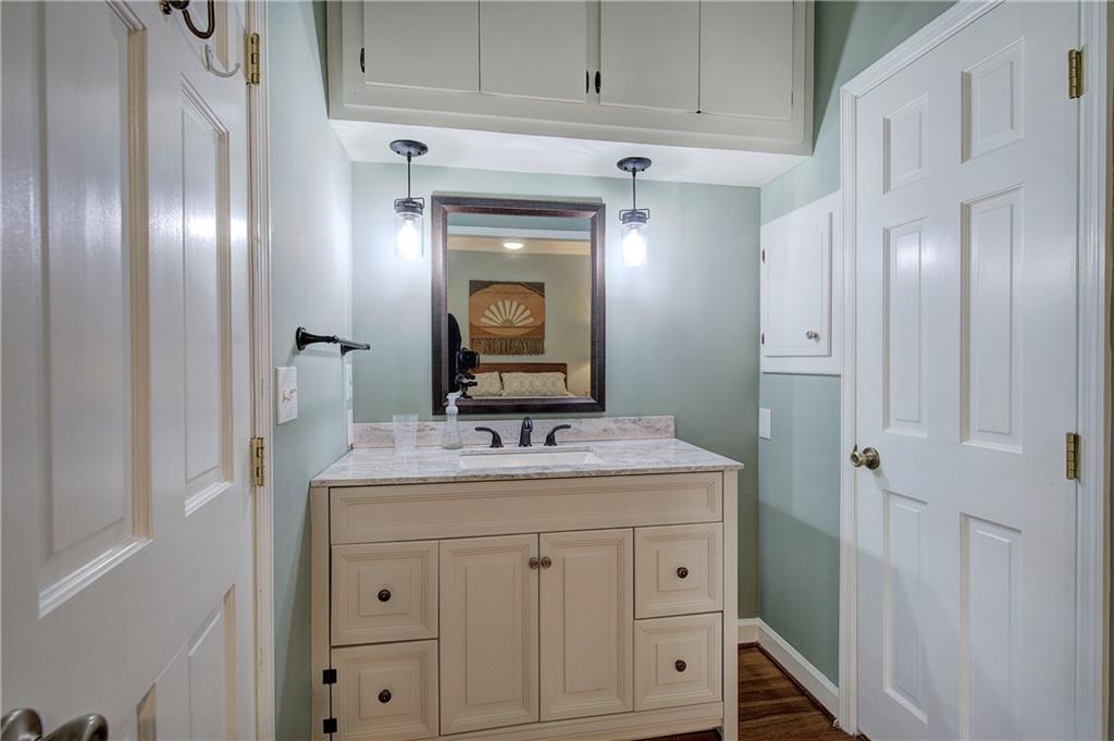 450 Little Hendricks Mountain Road Jasper, GA 30143 - Photo 31 of 61 a bathroom with a granite countertop sink and a mirror