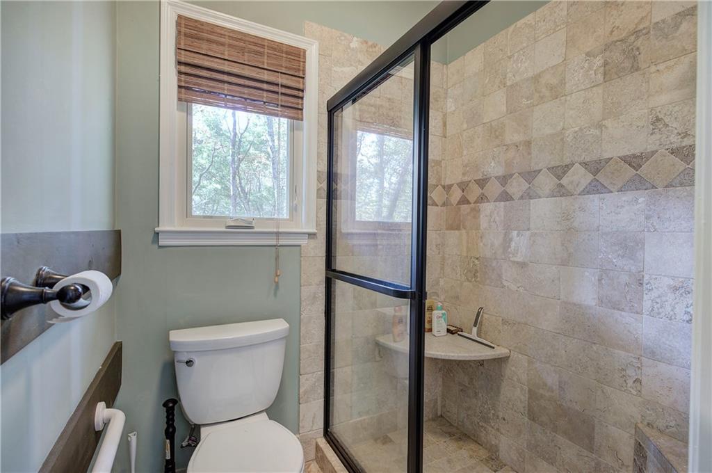 450 Little Hendricks Mountain Road Jasper, GA 30143 - Photo 32 of 61 a bathroom with a toilet and a shower