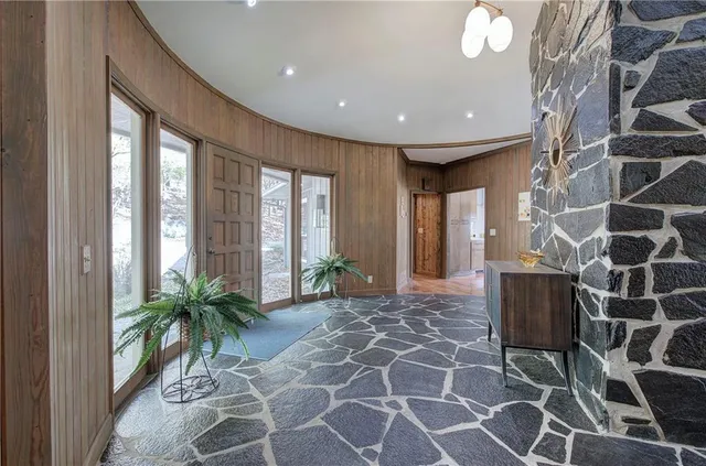 a living room with furniture a chandelier and a fireplace