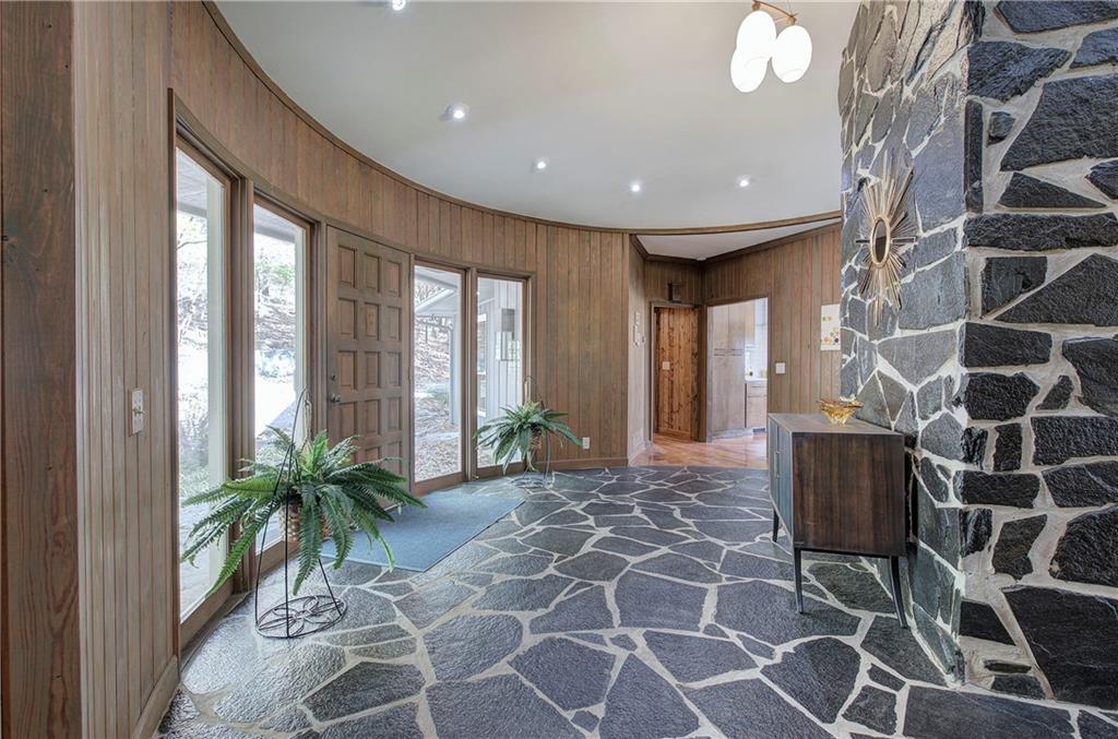 450 Little Hendricks Mountain Road Jasper, GA 30143 - Photo 6 of 61 a living room with a large window and potted plants
